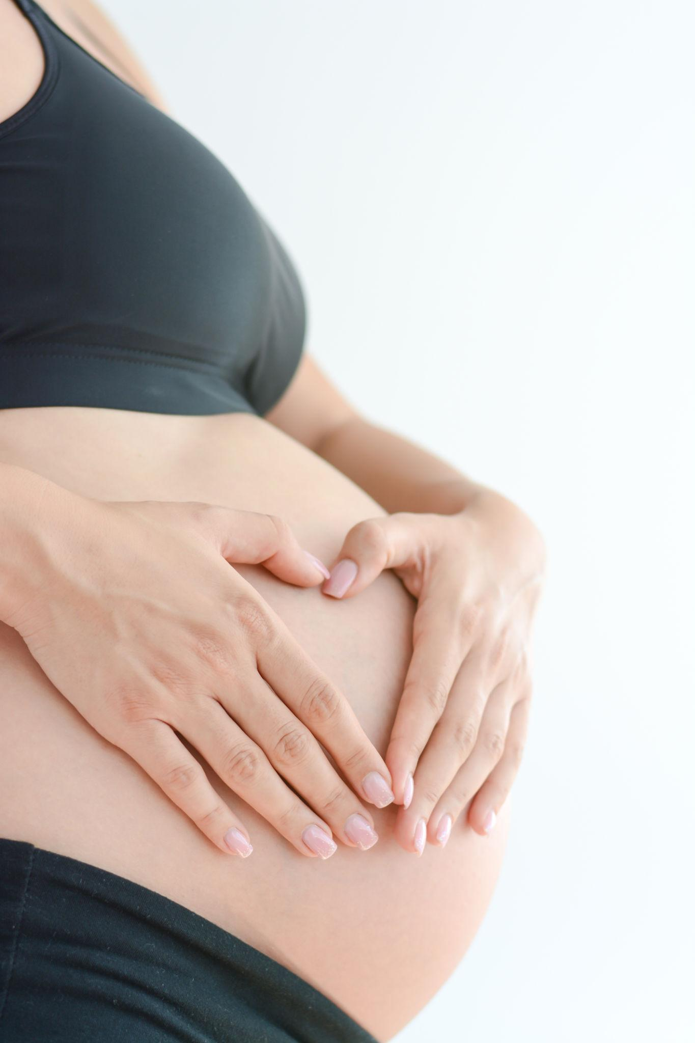 Pregnant woman holding her bump